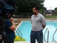 Man being interviewed at pool